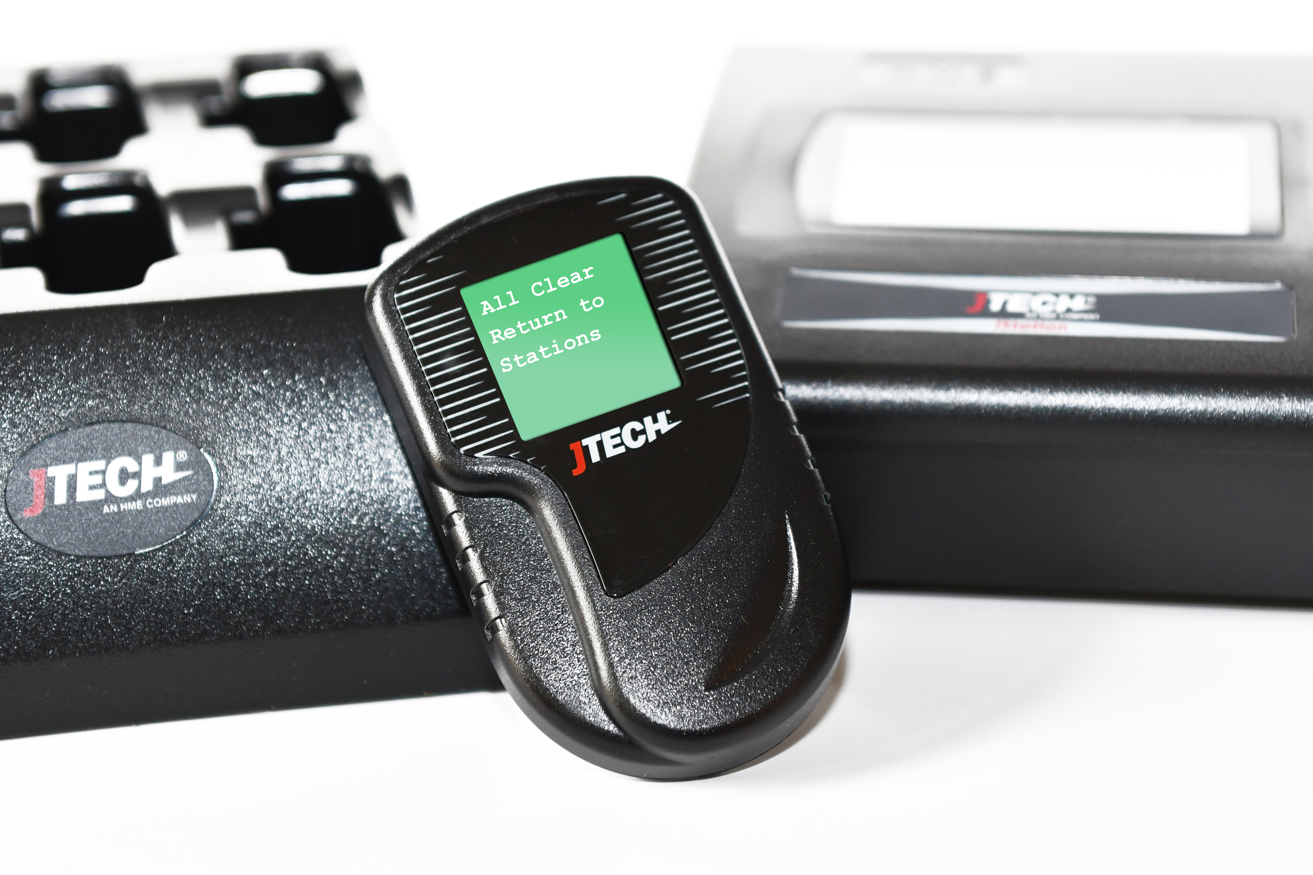 Pager Closeup with Faded Transmitter and Charger - Green - All Clear Return to Stations