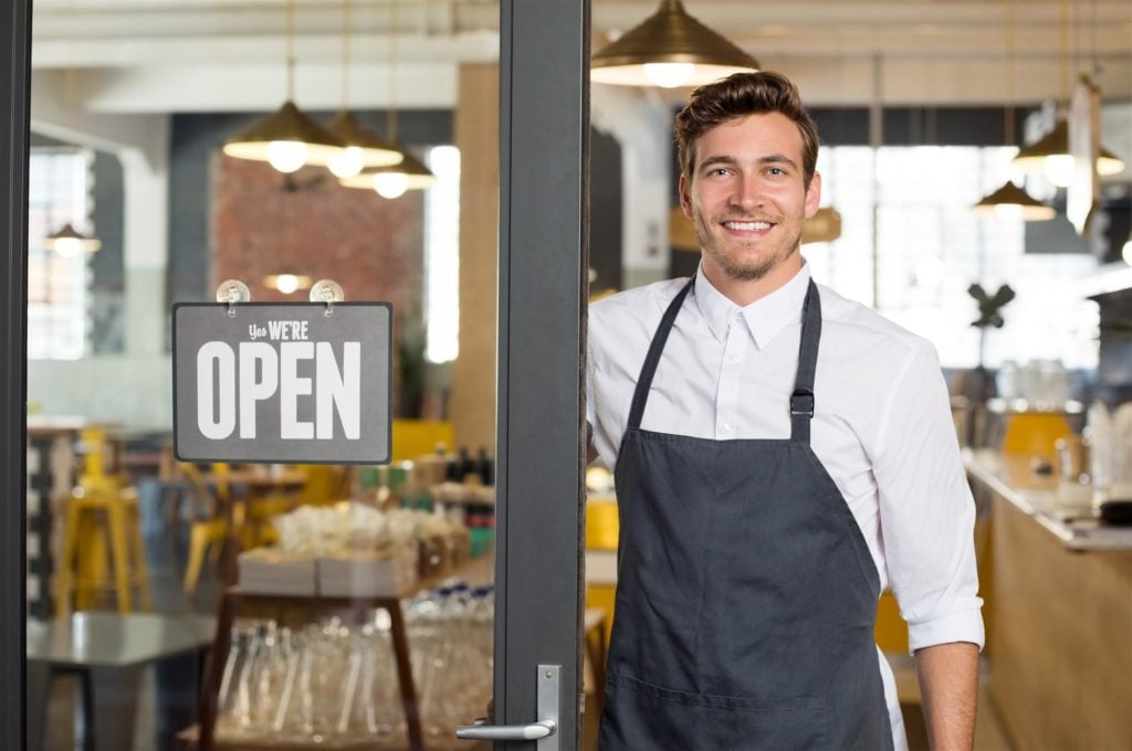 happy-restaurant-owner-standing